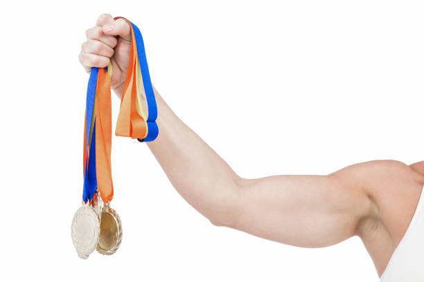 Female athlete holding medals on white background