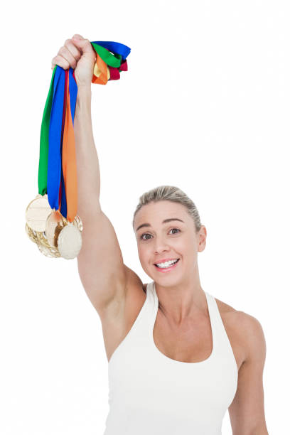 happy female athlete holding medals - effort gold indoors studio shot imagens e fotografias de stock