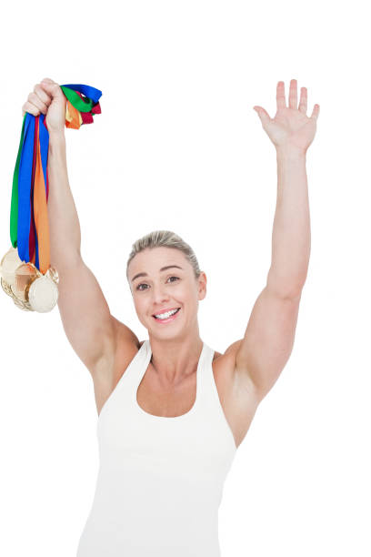 happy female athlete holding medals - effort gold indoors studio shot imagens e fotografias de stock