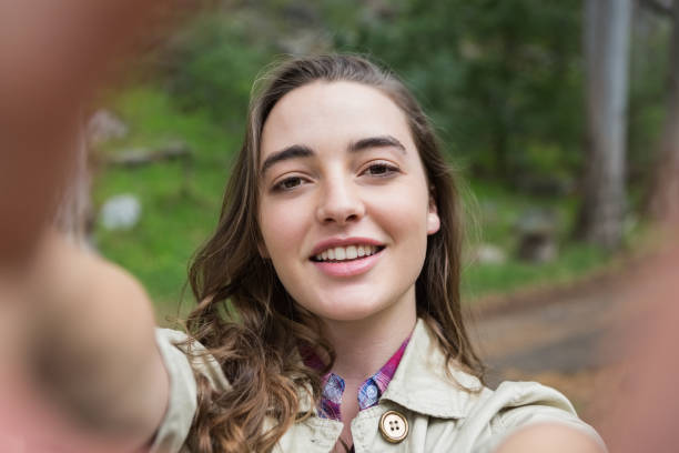 istock Smiling woman taking selfies 659717132