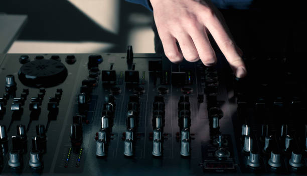 istock DJ hand mixing on audio board mixer 659751228