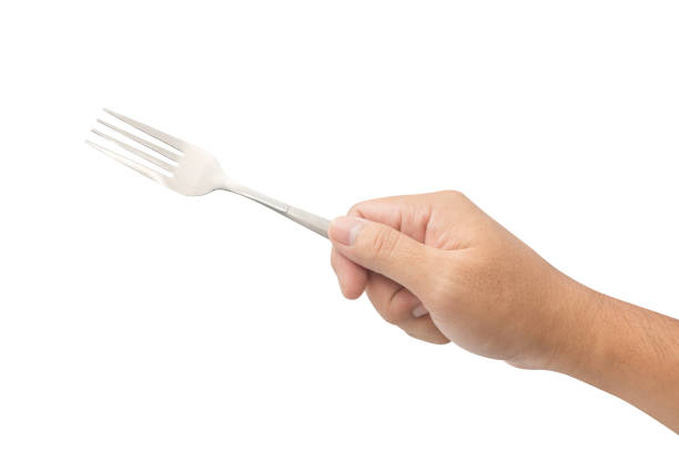 istock hand holding metal fork isolated on white background 659779564