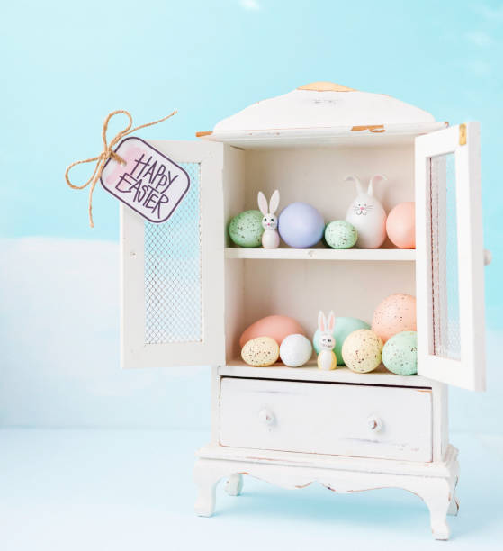 istock Easter collection of eggs and rabbits in white cabinet 659808884