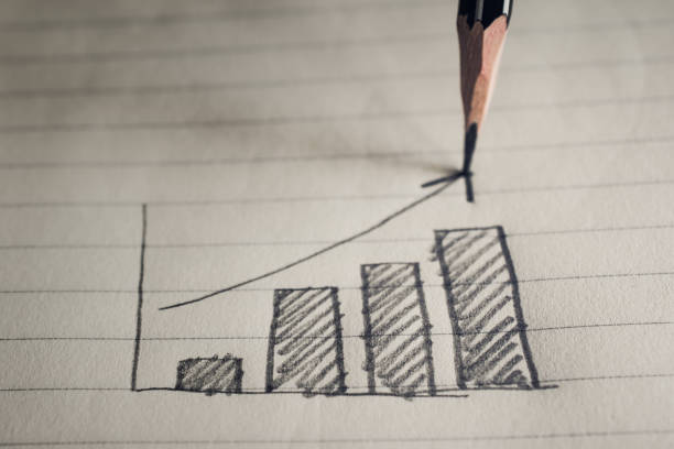 istock pencil drawing business graph on notebook paper business concept. 659810198