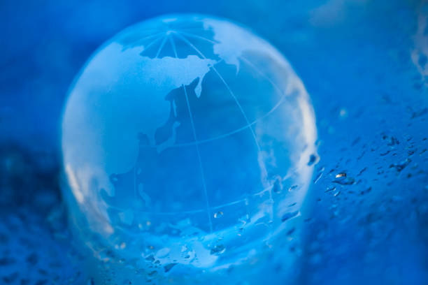 istock Blue Globe on the Wet Glass Board 659810596