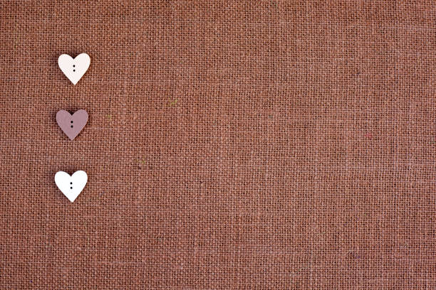 Background - brown burlap with heart shape buttons