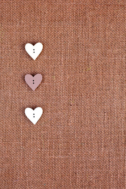 Background - brown burlap with heart shape buttons