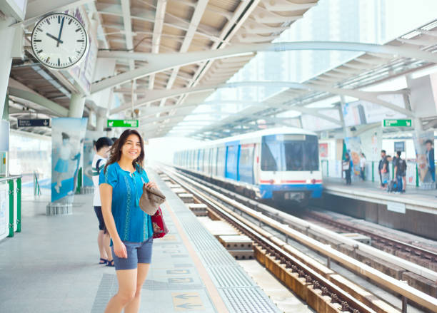 istock Teen girl standing on train platform station 659829694