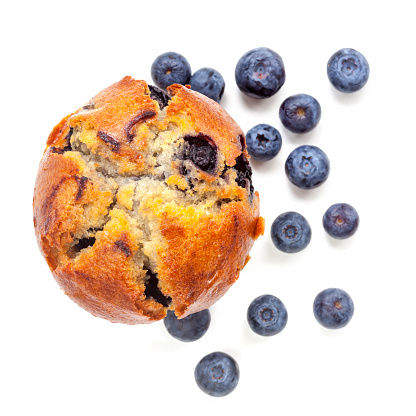Blueberry muffin, isolated on white, top view.  With fresh fruit.