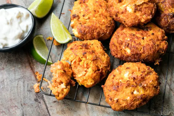 Fritters with carrots, sweet potato and feta cheese, served with yogurt and lime.