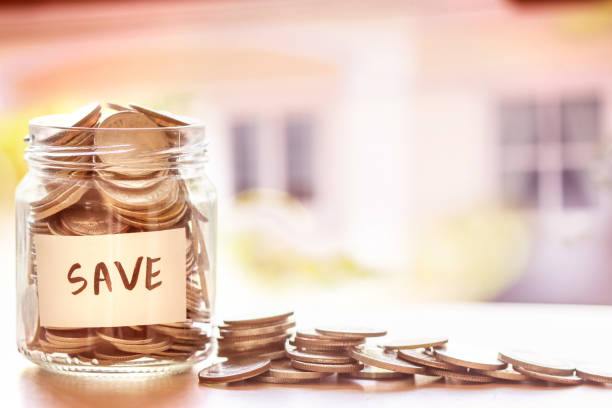 istock Coins in glass jar with house defocused background 659862046