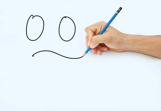 istock Hand holding a pencil on a white paper background. 659885726