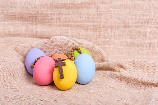 Wooden rosary beads on easter eggs
