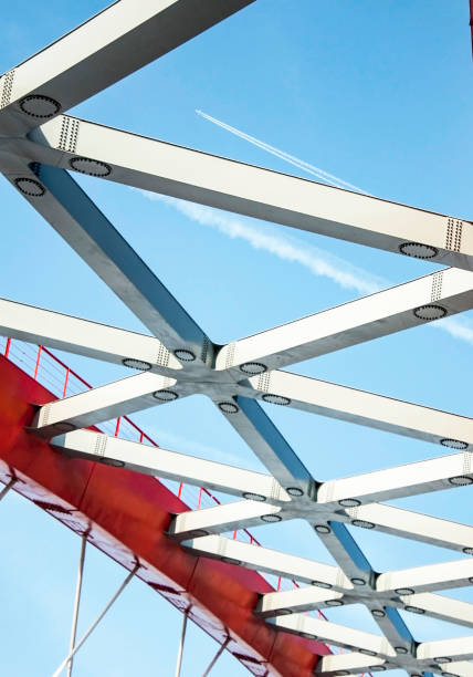 istock Airplane far in the sky, view from below through metal structures 659907864
