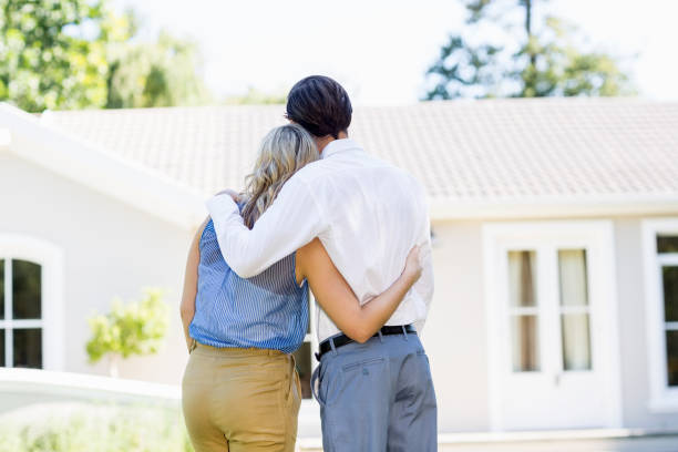 istock Rear view of couple standing with arm around 659917016