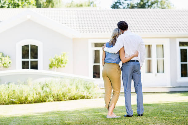 istock Rear view of couple standing with arm around 659917888