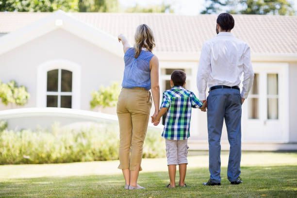 istock Parents and son standing in garden 659924220