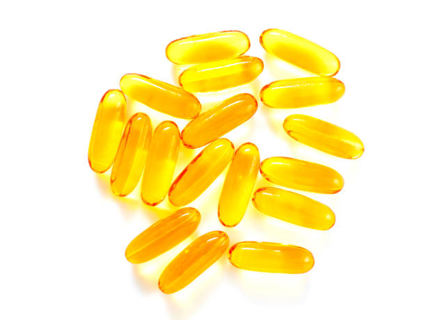 istock Close up fish oil capsules isolated on white background 659939584