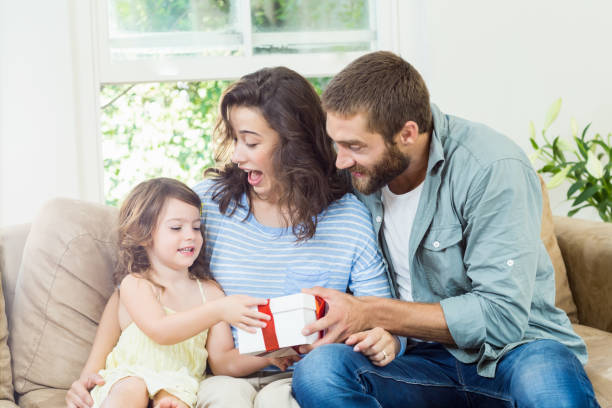 istock Daughter receiving surprise a gift from her parents 659950456