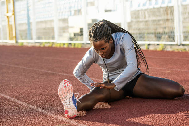 istock Female runner of african descent stretching her leg 659957880
