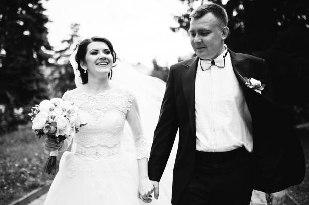 istock Happy wedding couple walking holding hands and smiling. 659959014