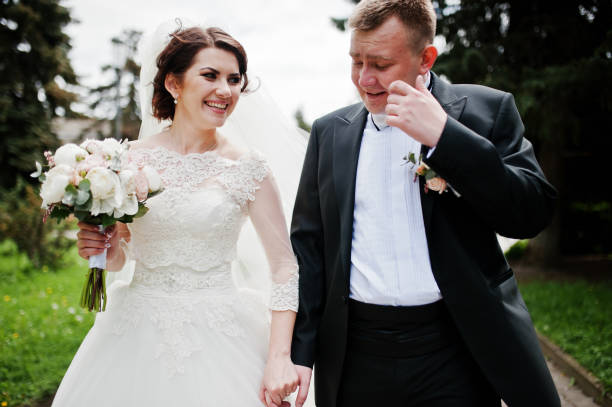 istock Happy wedding couple walking holding hands and smiling. 659959088