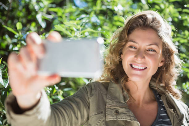 istock Smiling woman taking selfies 659966456