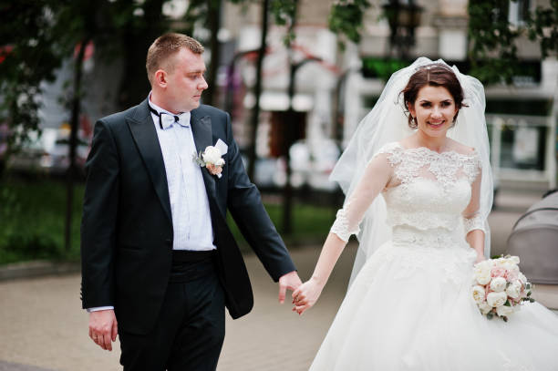 istock Newlyweds holding hand at their wedding day. 659974706