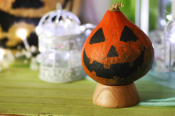 istock pumpkin head face and light garland 659982124