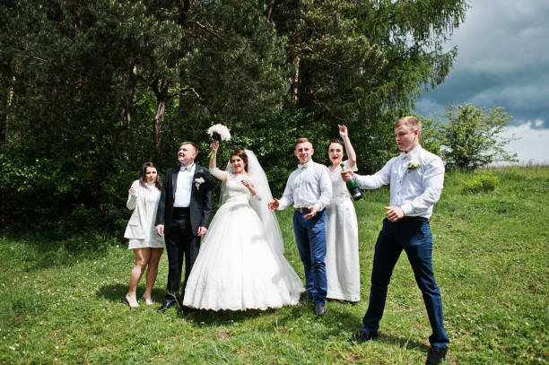 istock Wedding couple with their friends drinking champagne. 659988416