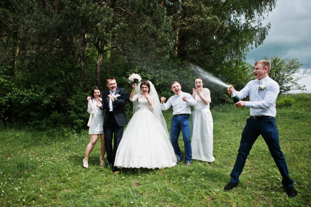istock Wedding couple with their friends drinking champagne. 659988458