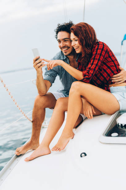 istock Friends texting on a yacht 659995638
