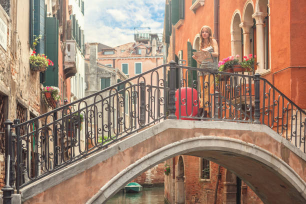 istock Lost in Venice - young tourist holding map 660003710