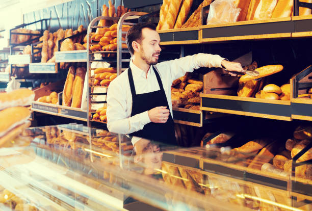 istock Seller offering fresh loaf of bread 660041746