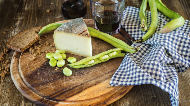 Food: beans and pecorino cheese Taglliere with broad beans and pecorino cheese and accompanied by red wine broad bean plant stock pictures, royalty-free photos & images