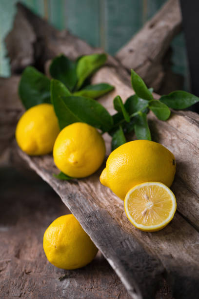 istock Fresh ripe lemons on Dark vintage wood texture background 660058140