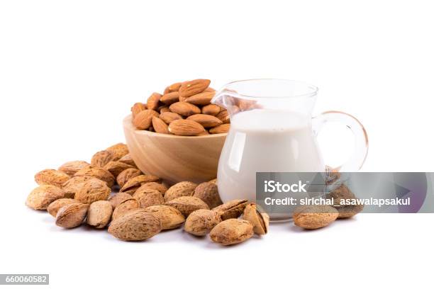 Glass Of Almond Milk With A Heap Of Almonds On White Background Stock Photo - Download Image Now