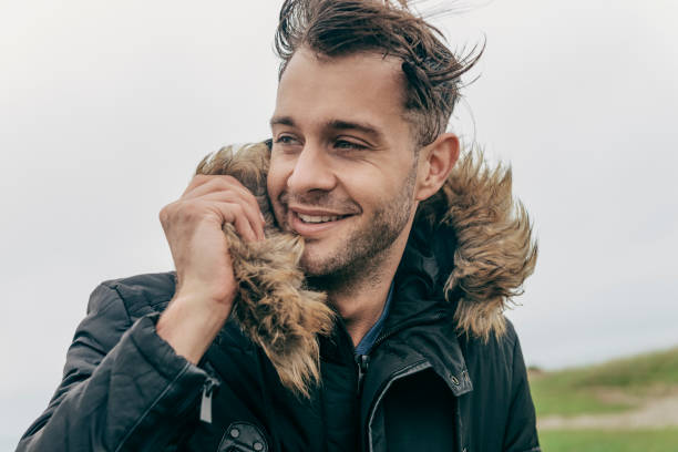 istock Man wearing black jacket walking along the Cornish Coast, Newquay 660081620