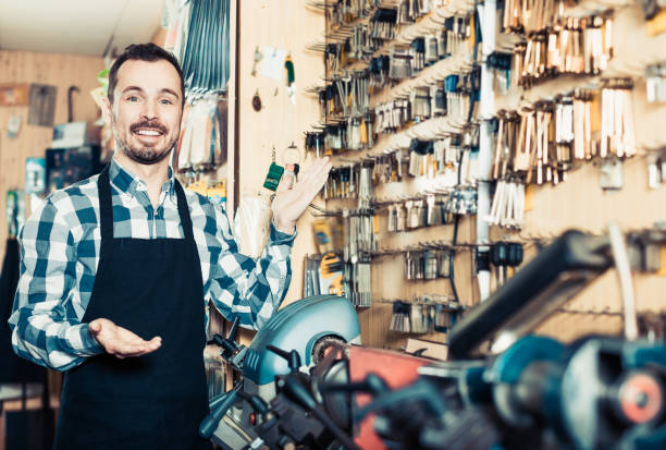 istock Adult man displaying his tools for making keys 660100628