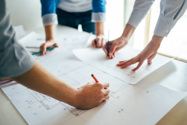 istock Team of architects checks construction blueprints 660130792