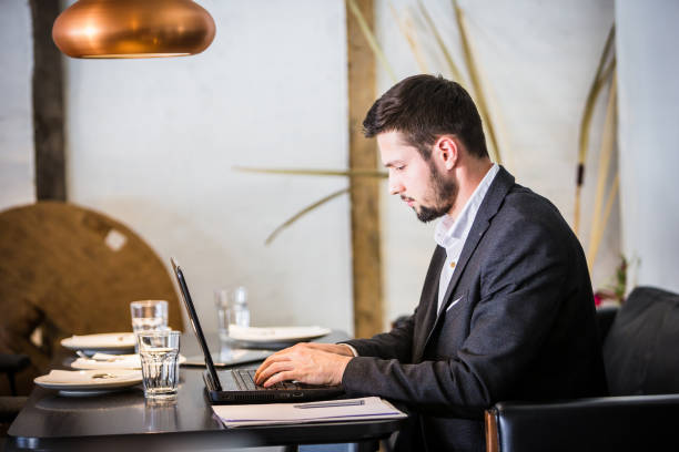 istock Handsome businessman, working on laptop, browsing some papers. 660142064
