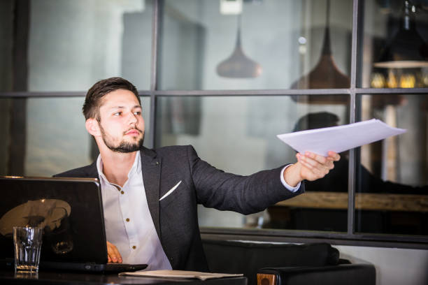 istock Handsome businessman, working on laptop, browsing some papers. 660142188