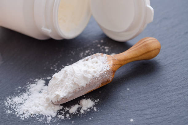 istock wooden scoop with probiotic powder on black 660144230
