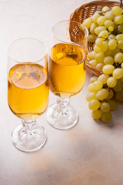 istock White wine and grapes. White wine in glasses and grapes 660149502