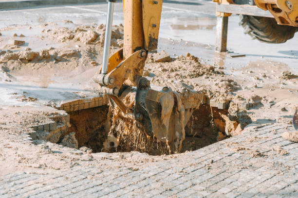 istock Excavator cleaning mud from area with broken pipeline 660149716