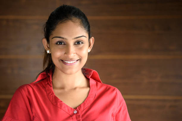 Portrait of young businesswoman in pink blouse, smiling Attractive Sri Lankan woman in her 20s facing camera with cheerful expression sri lanka business stock pictures, royalty-free photos & images