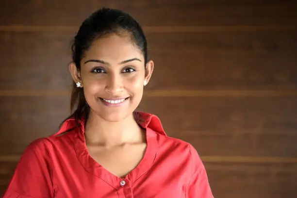 Photo of Portrait of young businesswoman in pink blouse, smiling