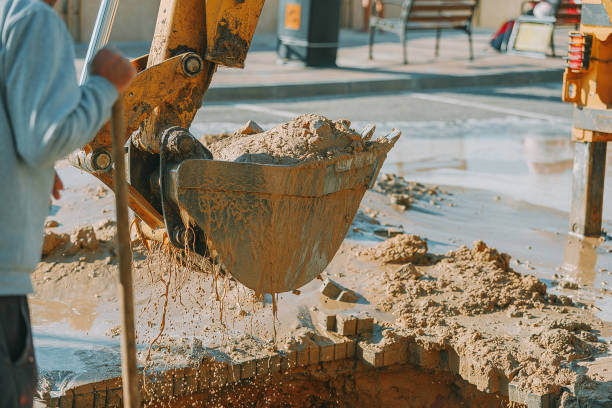 istock Excavator cleaning mud from area with broken pipeline 660150150