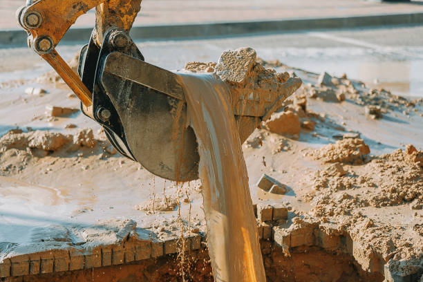 istock Excavator cleaning mud from area with broken pipeline 660150582