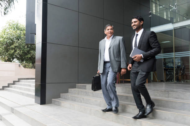 istock Two male business colleagues outside modern office on steps 660151870